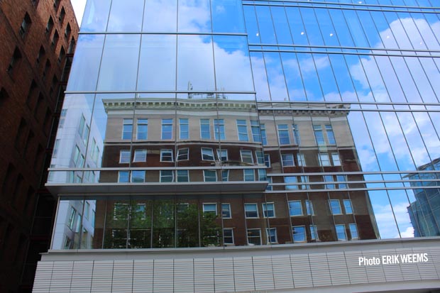 Reflected building of brick in the glass